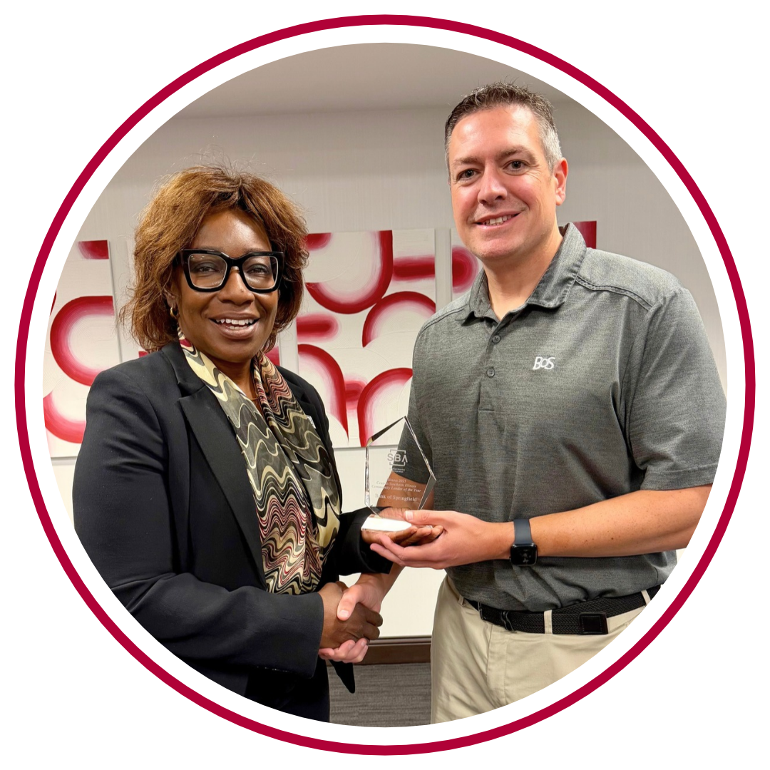 Accepting the Award is Tom Rodden standing with the U.S. SBA District Director, Willette LeGrant.